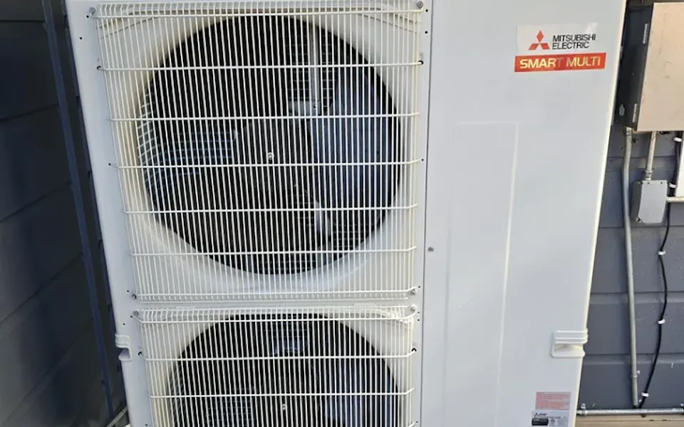 Mitsubishi Electric outdoor unit beside a home