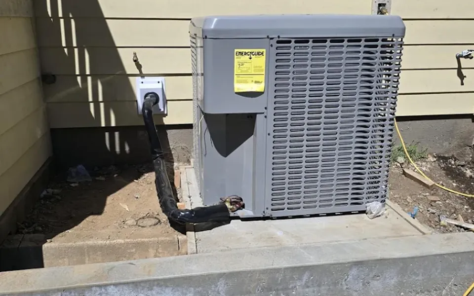 Central air conditioning unit on a concrete equipment pad